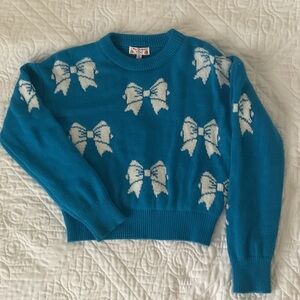 Poof! Teal Sweater with White Bow Design